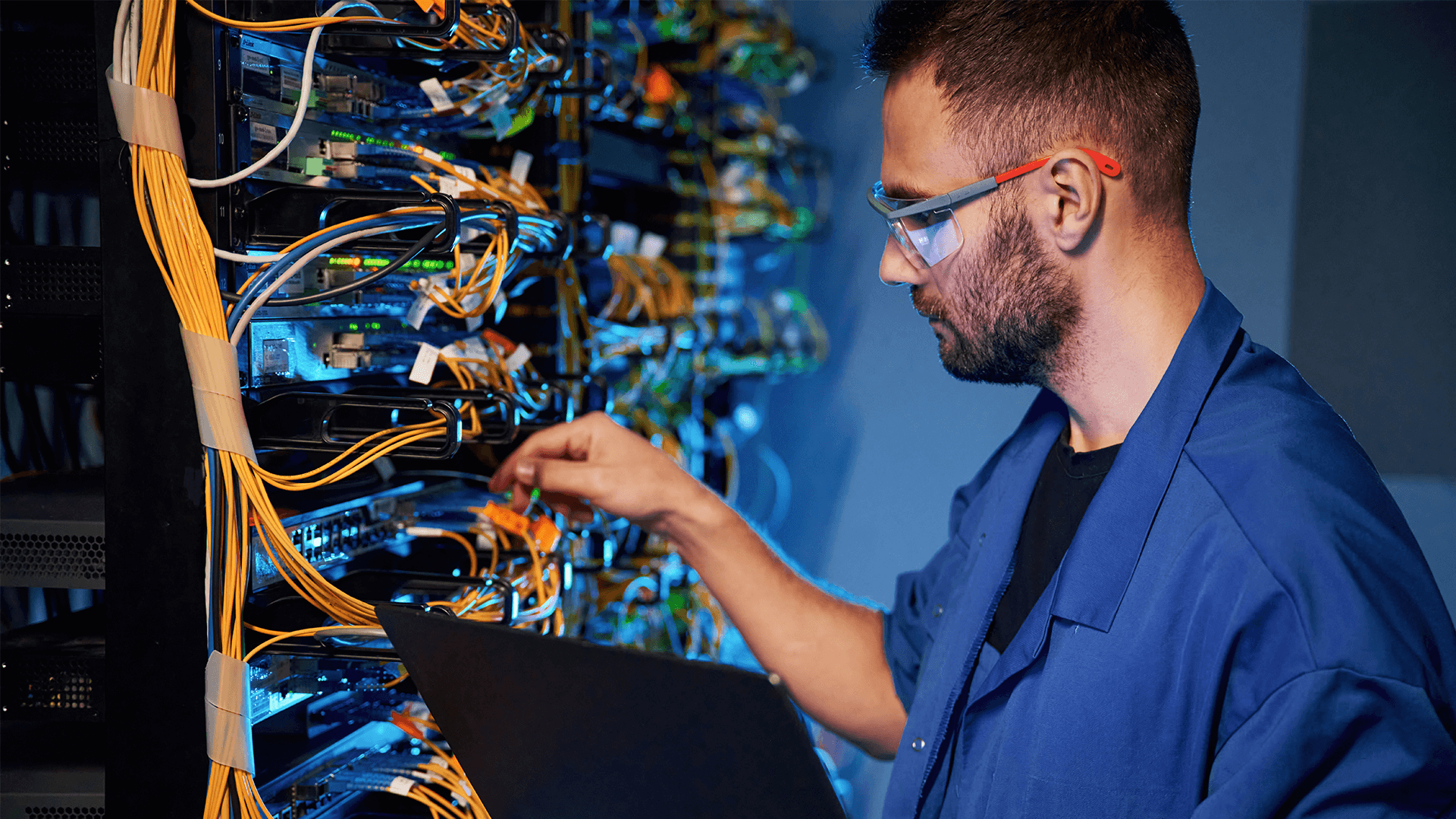 technician ensuring cable management in a server room by organizing wires
