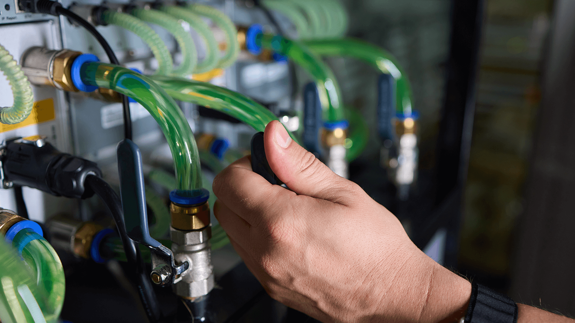 person installing a liquid cooling system in a data center