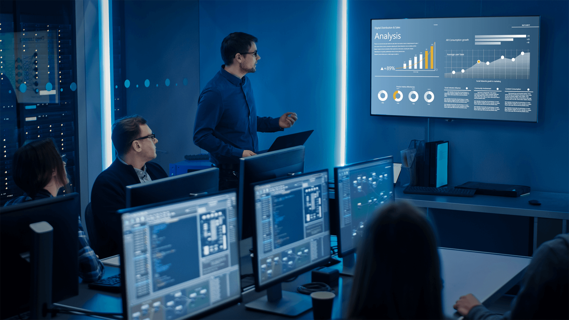 Team Of It Experts Looking At Data Analysis Presentation